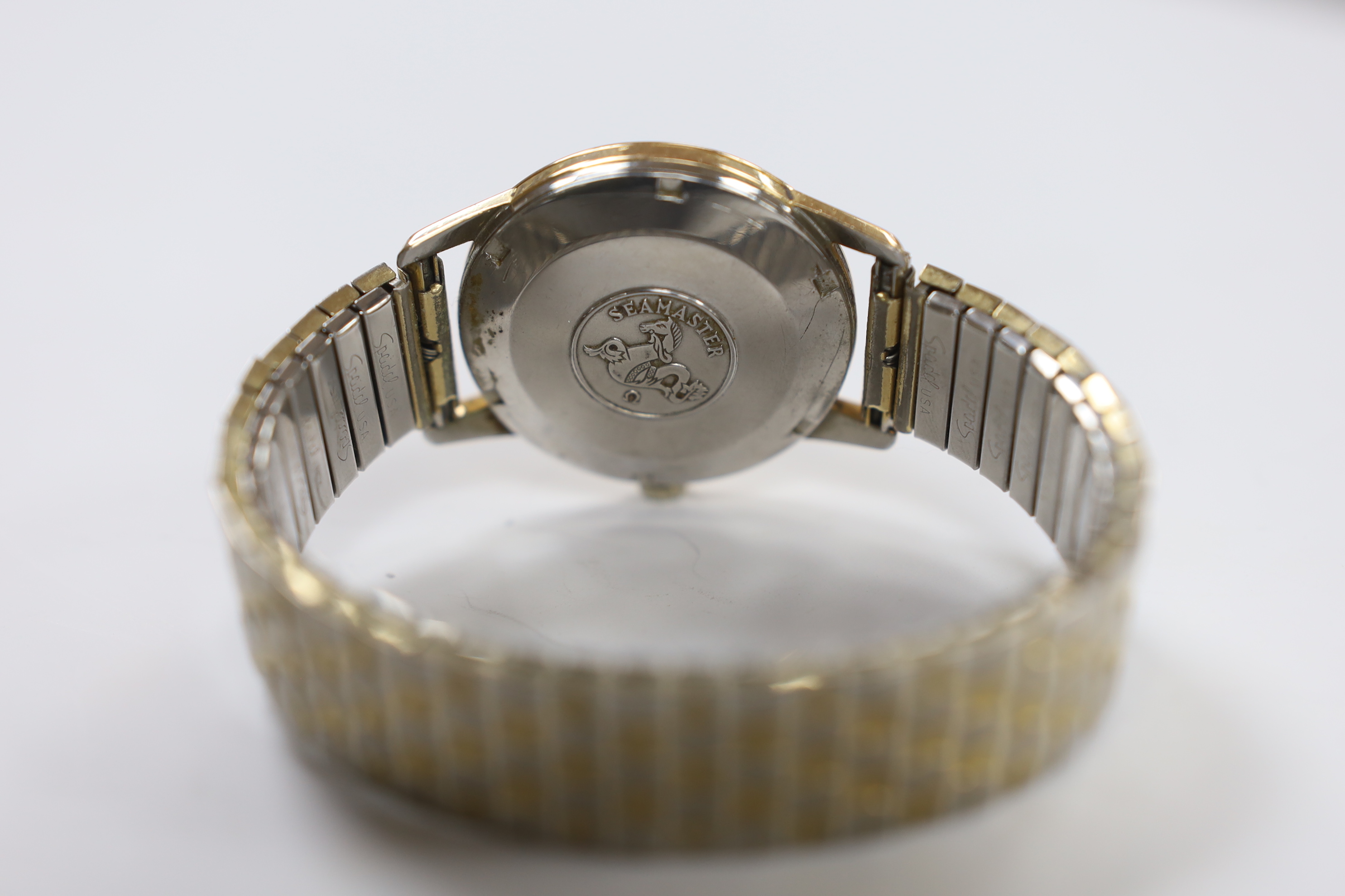 A gentleman's steel and gold plated Omega Seamaster manual wind wrist watch, cased diameter 35mm, on a later associated flexible bracelet.